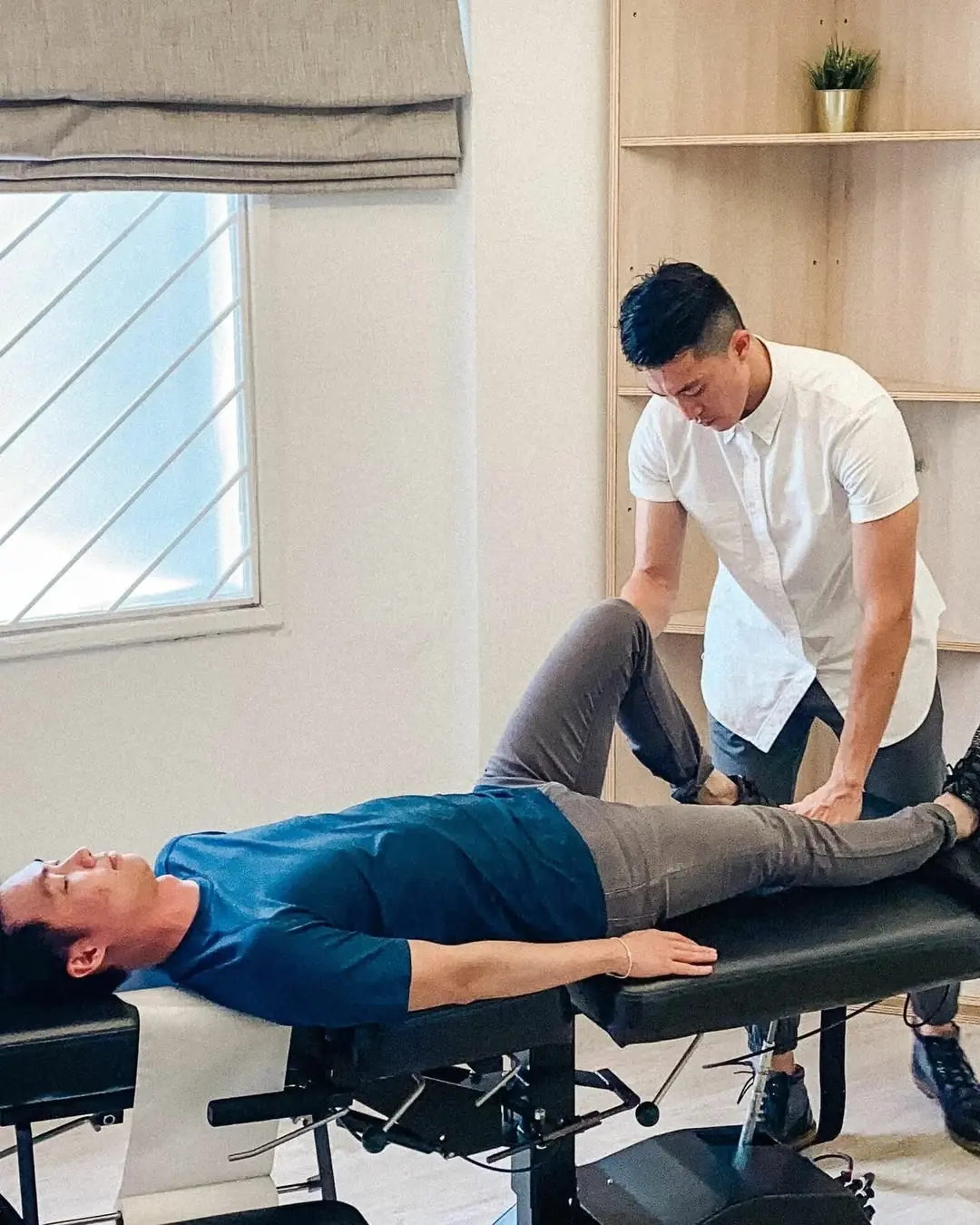 Dr. Ben assessing lower-limb movement during a clinical consultation
